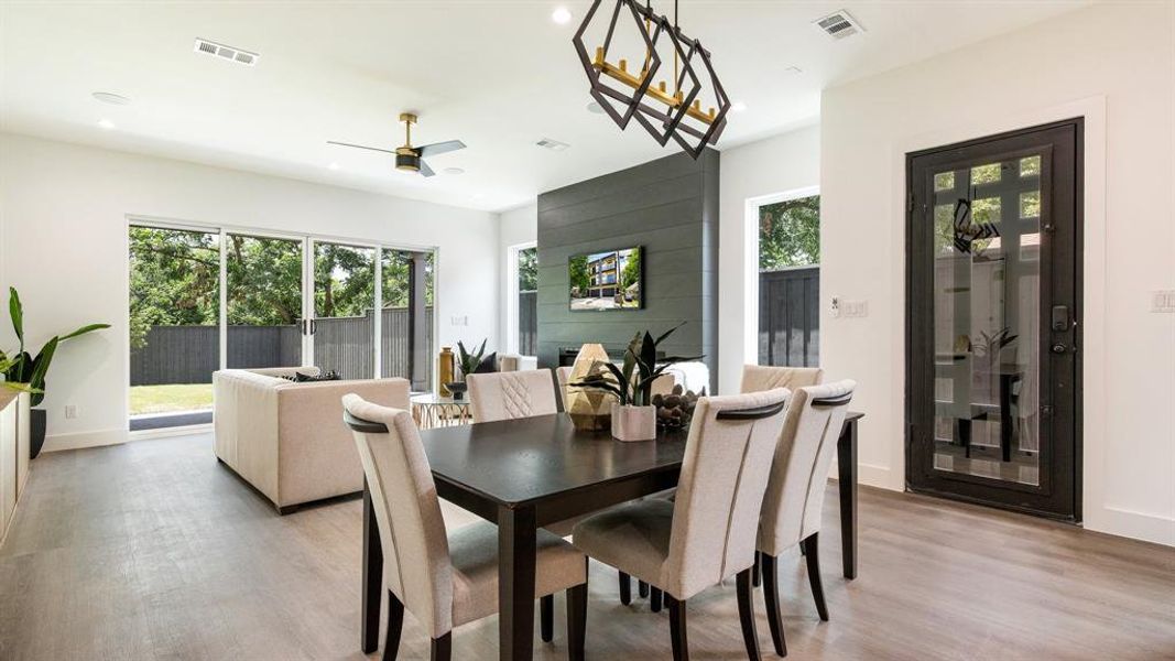 Dining room with light hardwood / wood-style floors and ceiling fan