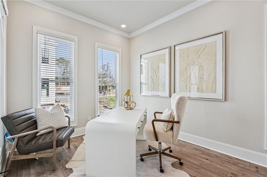 Office space featuring wood-type flooring, crown molding, and recessed lighting