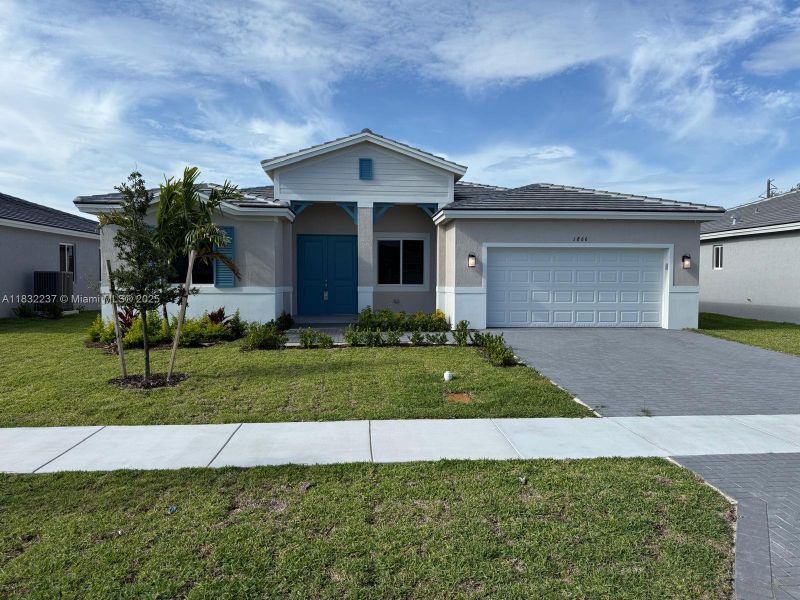 Front exterior of a new home in , Homestead, FL, highlighting curb appeal (Image 2).