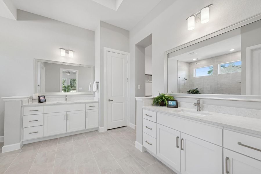 Dual vanities, high ceiling and walk in shower all compliment this beautiful bath.