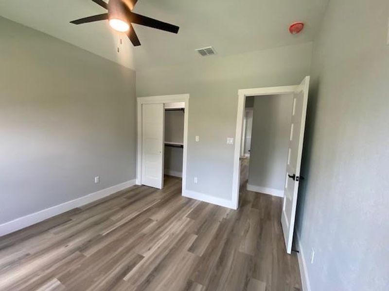 A quiet retreat with stylish wood flooring and a refreshing ceiling fan. A quiet retreat with stylish wood flooring and a refreshing ceiling fan.