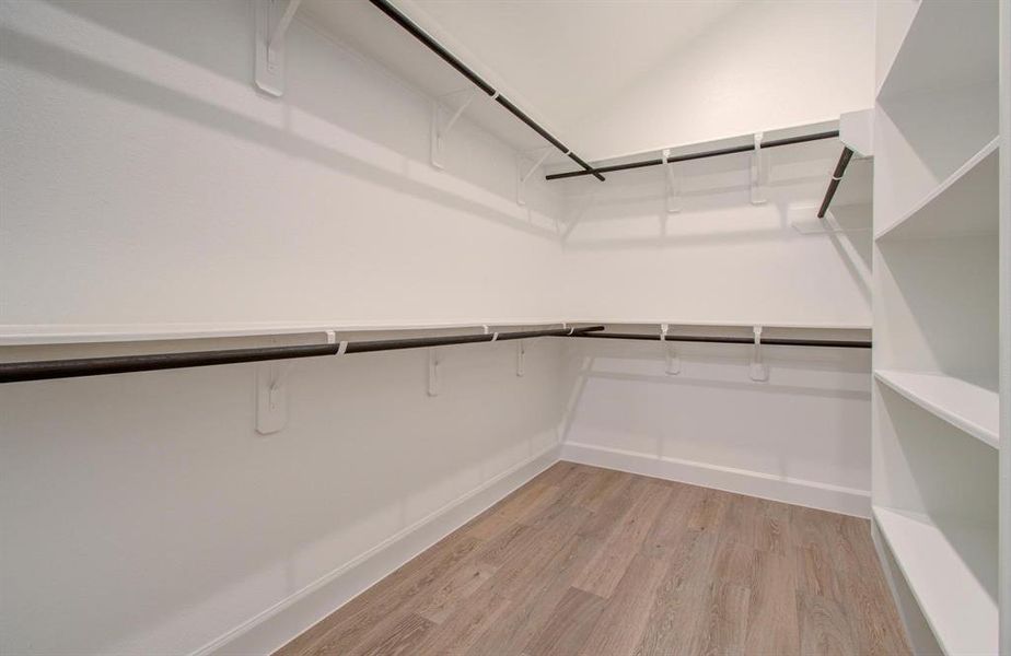 Deep walk-in closet in primary bedroom.