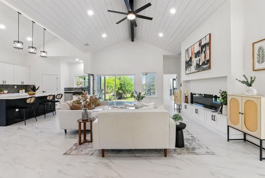 Living area featuring light tile finish flooring, and high ceiling