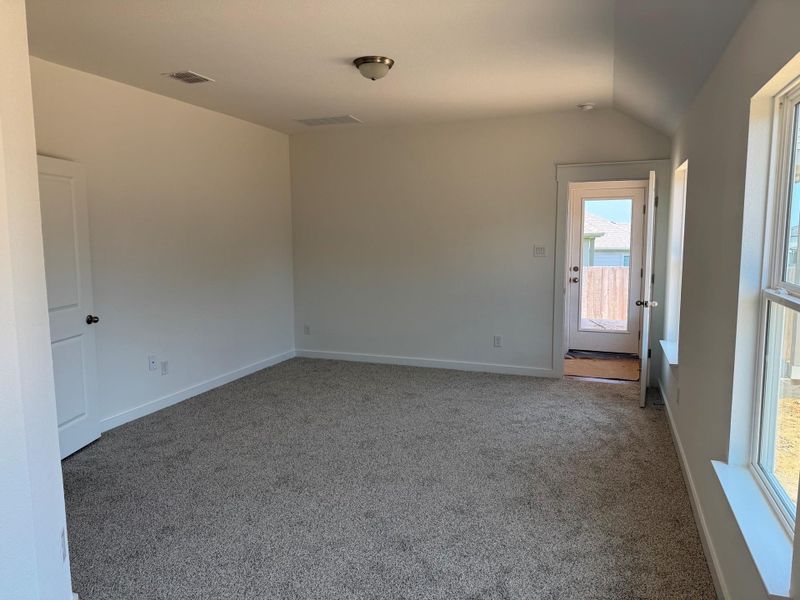Unfurnished room featuring carpet and vaulted ceiling Unfurnished room featuring carpet and vaulted ceiling