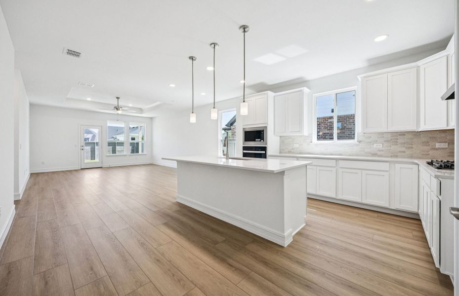 Spacious kitchen with oversized island *real home pictured