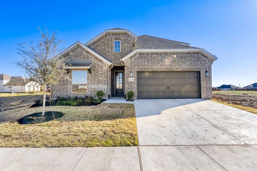 Front exterior of a new home in Wellington, Fort Worth, TX, highlighting curb appeal (Image 1). Front exterior of a new home in Wellington, Fort Worth, TX, highlighting curb appeal (Image 1).
