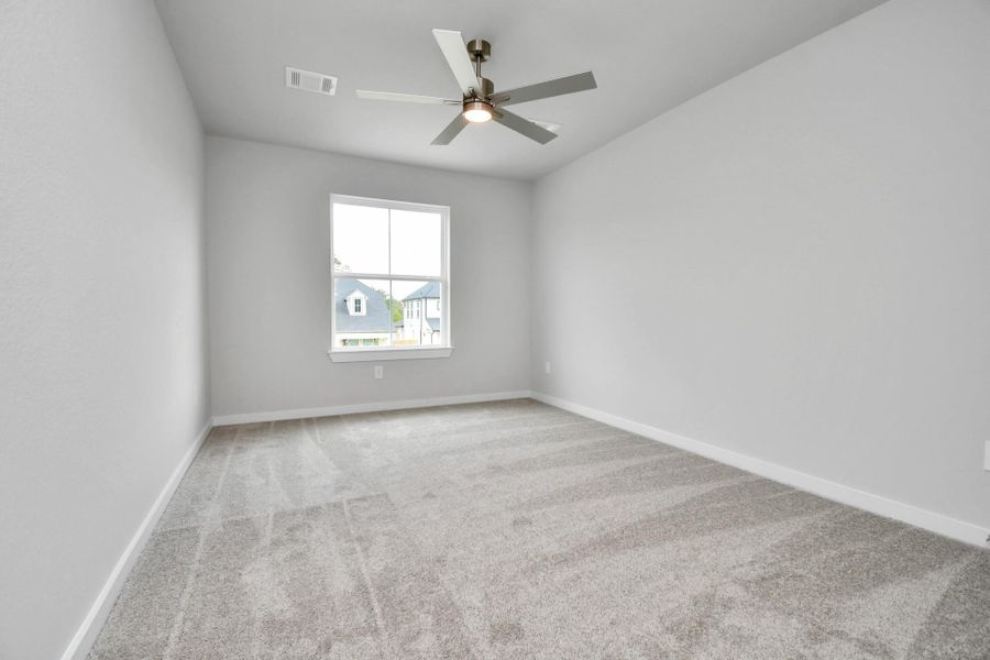 Secondary bedroom features plush carpeting, large windows that let in plenty of natural light, bright paint, and spacious closets. Sample photo of completed home with similar floor plan. Actual colors and selections may vary. Secondary bedroom features plush carpeting, large windows that let in plenty of natural light, bright paint, and spacious closets. Sample photo of completed home with similar floor plan. Actual colors and selections may vary.