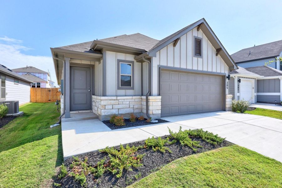 Front exterior of a new home in Trinity Ranch, Elgin, TX, highlighting curb appeal (Image 1).