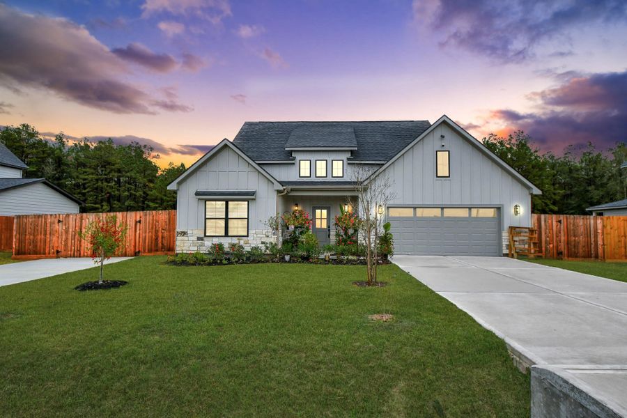 Front exterior of a new home in Spring Branch Crossing, Conroe, TX, highlighting curb appeal (Image 1). Front exterior of a new home in Spring Branch Crossing, Conroe, TX, highlighting curb appeal (Image 1).