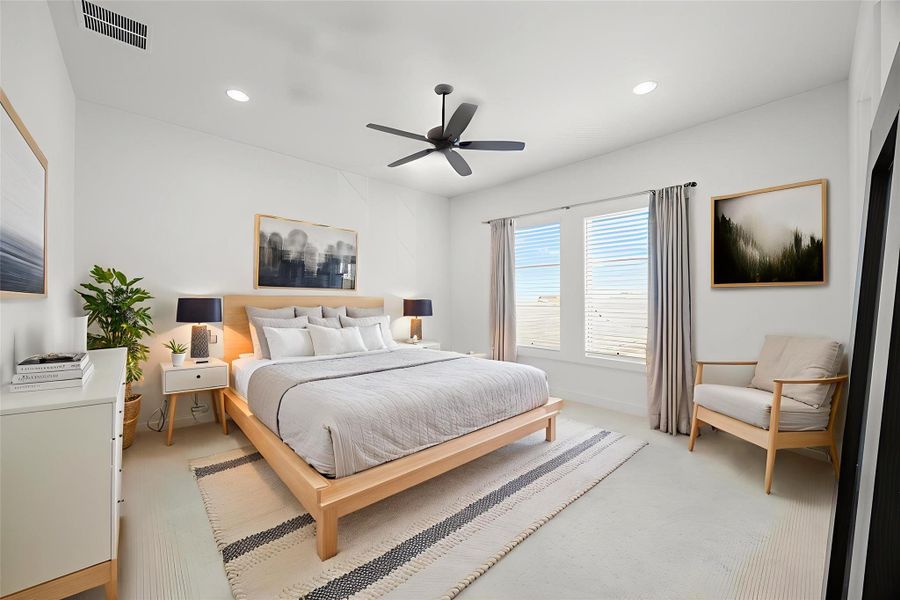 Virtually staged. Carpeted bedroom featuring recessed lighting and a ceiling fan