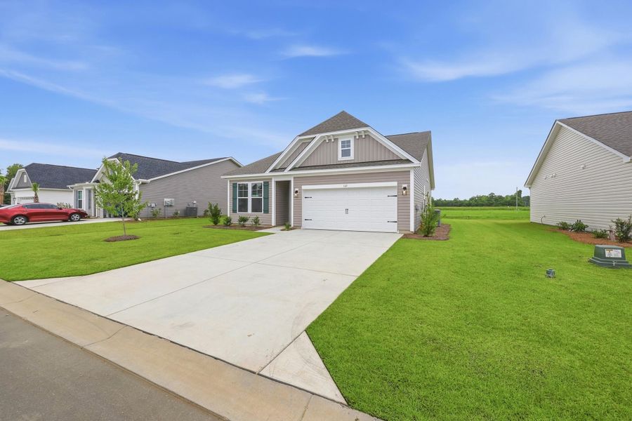 Front exterior of a new home in Edgefield, Loris, SC, highlighting curb appeal (Image 15). Front exterior of a new home in Edgefield, Loris, SC, highlighting curb appeal (Image 15).