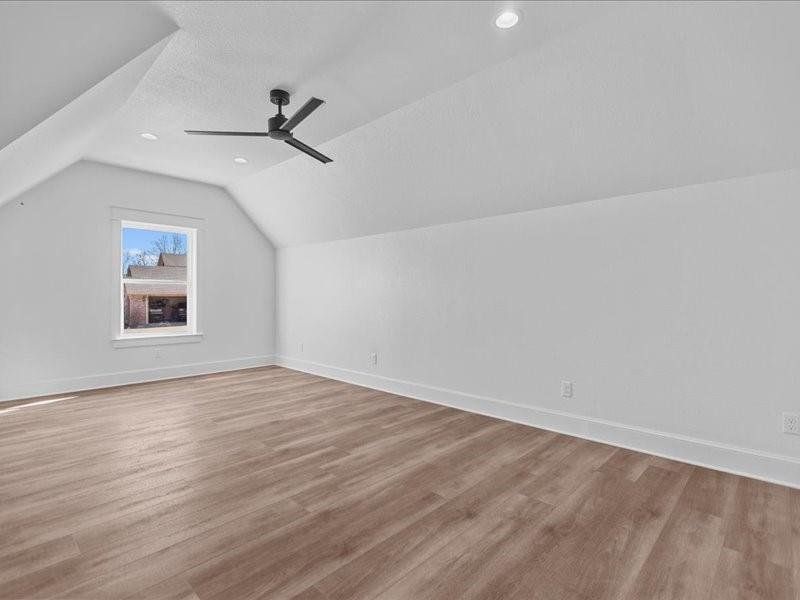 Bonus room featuring lofted ceiling, light wood-type flooring, ceiling fan, and recessed lighting