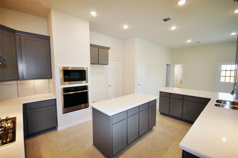 The utility room is just off the kitchen and exits to the porte cochere for easy access for groceries and children.