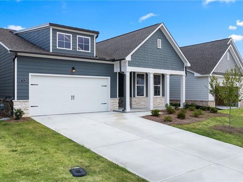 Front exterior of a new home in Kelly Preserve, Loganville, GA, highlighting curb appeal (Image 1).