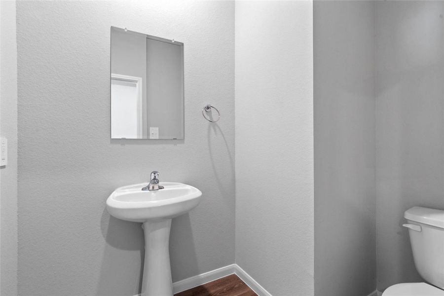 Strategically located on the main level, this half-bath allows guests to freshen up easily without having to navigate through the private areas of the home, such as the bedrooms or personal full bathrooms.