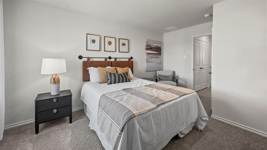 Bedroom featuring carpet and baseboards