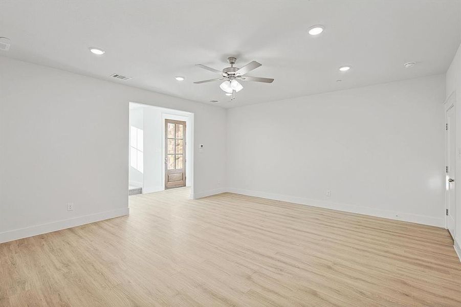 Empty room with recessed lighting, light wood-style flooring, baseboards, and ceiling fan