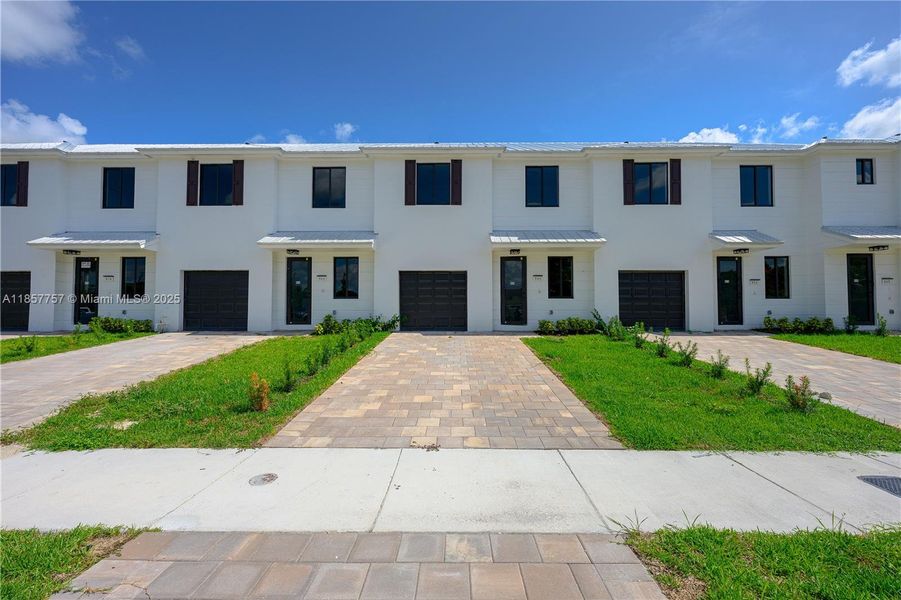 Front exterior of a new home in , Florida City, FL, highlighting curb appeal (Image 24). Front exterior of a new home in , Florida City, FL, highlighting curb appeal (Image 24).