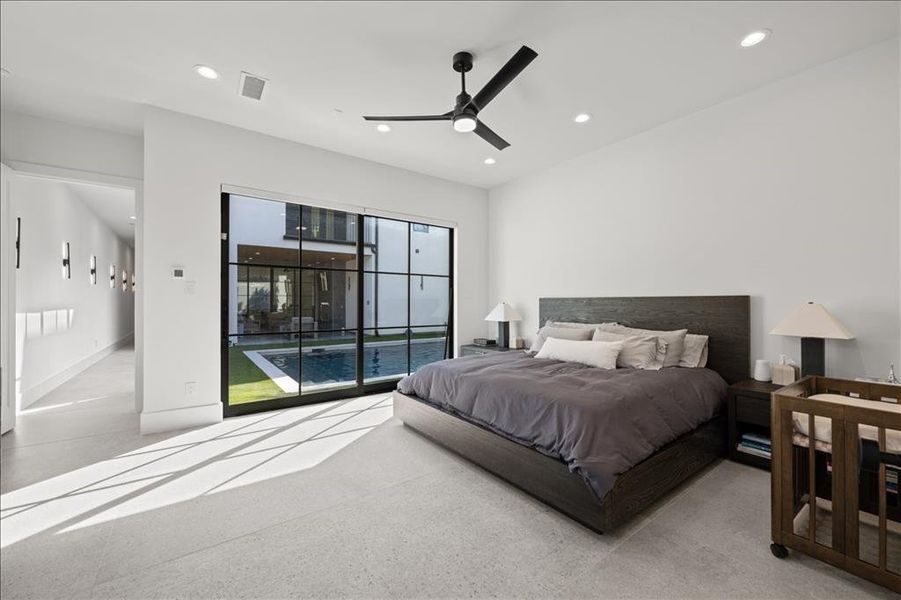 1st Primary bedroom featuring access to outside, recessed lighting, a ceiling fan, and dark aggregate flooring and direct pool access/views.