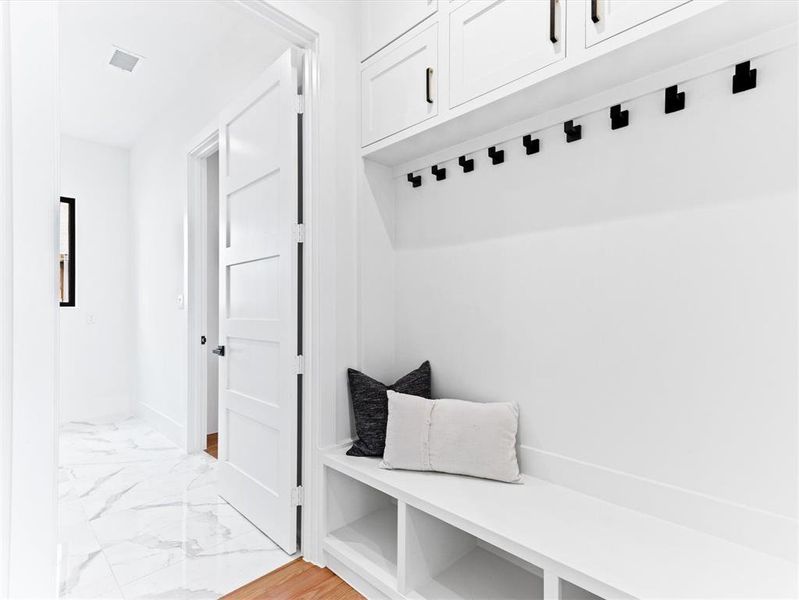 Mudroom with light tile floors