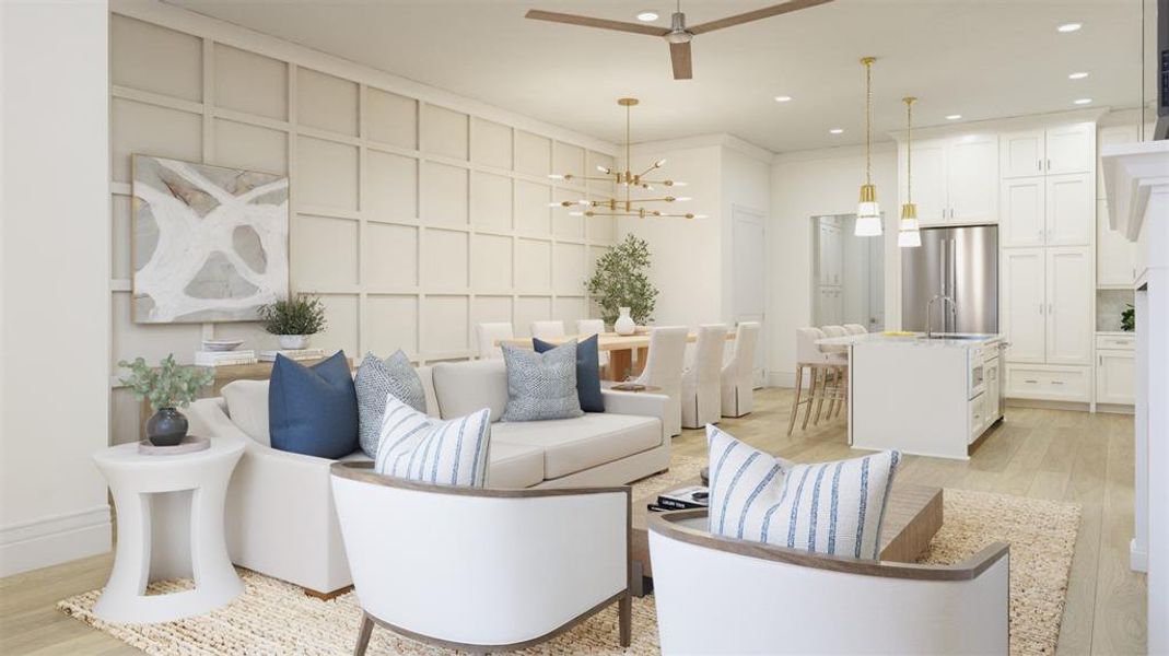 Living room featuring light wood-type flooring, ceiling fan with notable chandelier, and sink