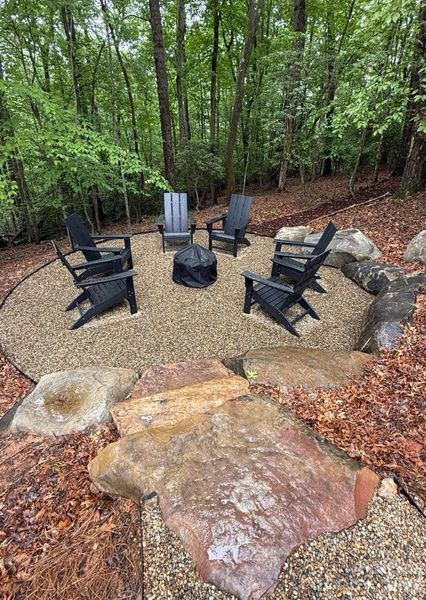 Stone steps lead to a cozy gathering spot and s'mores by the fire pit