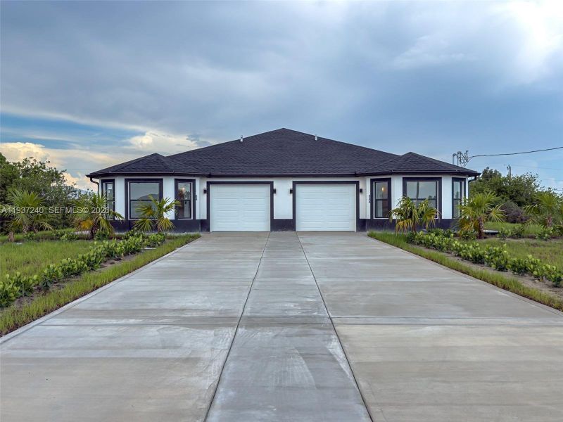 Front exterior of a new home in , Lehigh Acres, FL, highlighting curb appeal (Image 20).