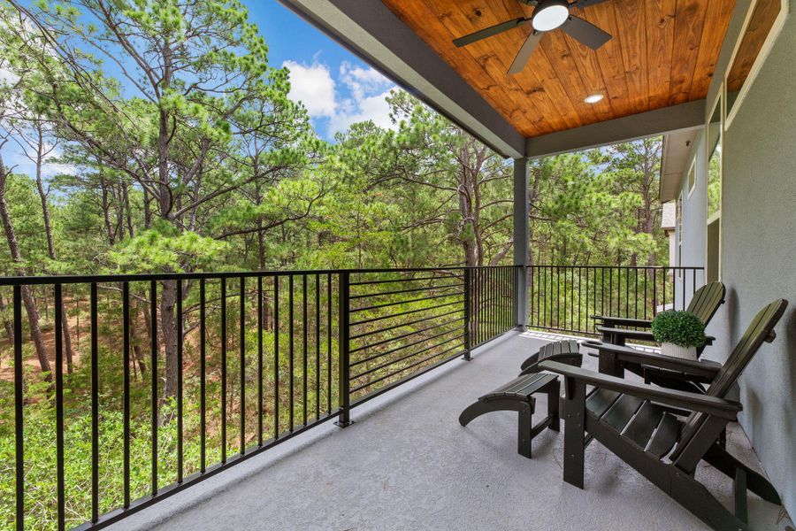 A tranquil covered deck, ideal for enjoying serene woodland views with comfort and privacy.
