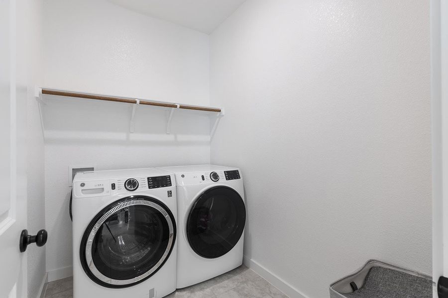 Laundry room featuring baseboards and separate washer and dryer
