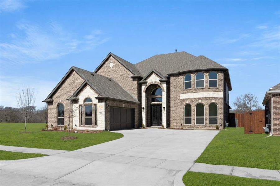 Front exterior of a new home in High Country, Burleson, TX, highlighting curb appeal (Image 23).