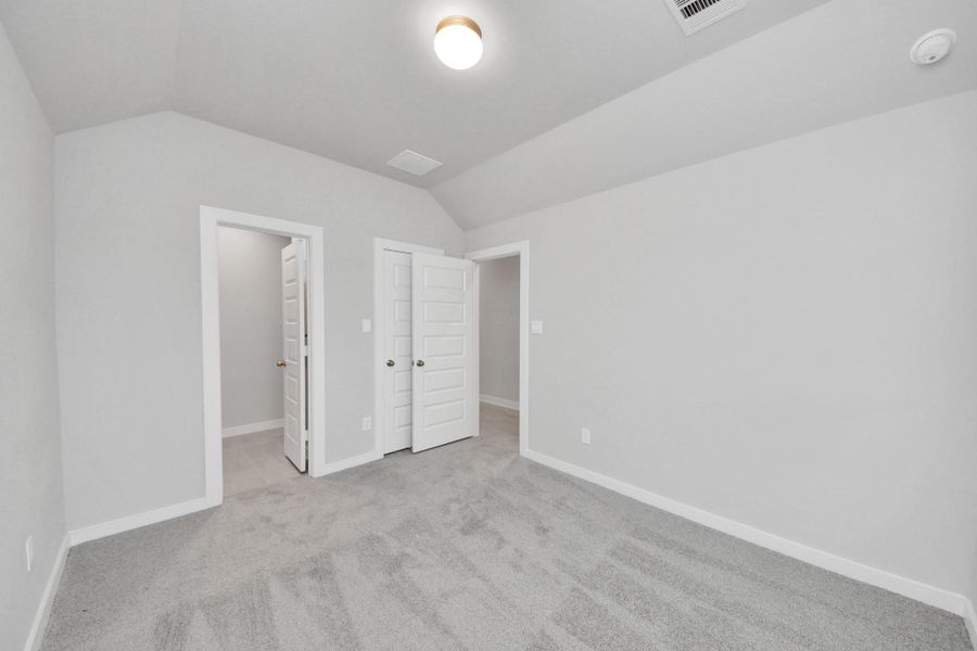 Generously sized secondary bedrooms featuring spacious closets, soft and inviting carpeting underfoot, large windows allowing plenty of natural light, and the added touch of privacy blinds for your personal retreat. Sample photo of completed home with similar floor plan. Actual colors and selections may vary.