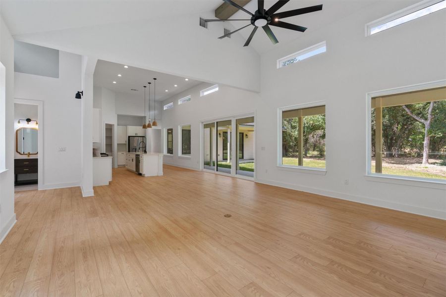 A spacious, naturally illuminated great room boasts a high ceiling and ample room for daily living and entertaining.