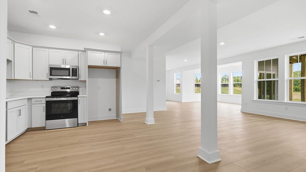 Highly skilled design choices create a clean, open kitchen located in the basement at the Pinebrook community