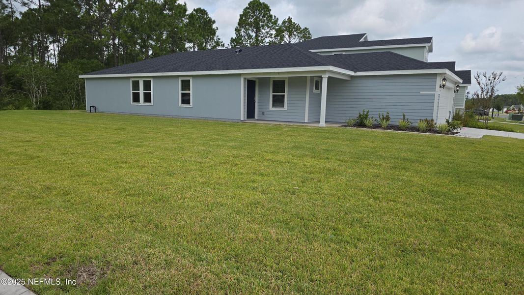 Front exterior of a new home in Flagler Village - Classic Series, Palm Coast, FL, highlighting curb appeal (Image 2). Front exterior of a new home in Flagler Village - Classic Series, Palm Coast, FL, highlighting curb appeal (Image 2).