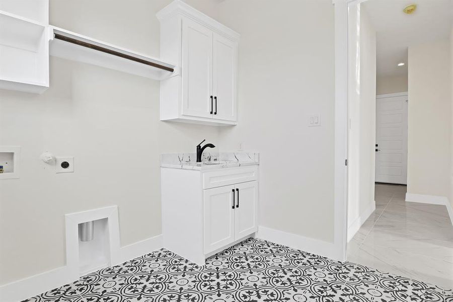 Laundry area with sink, cabinets, electric dryer hookup, washer hookup, and hookup for a gas dryer