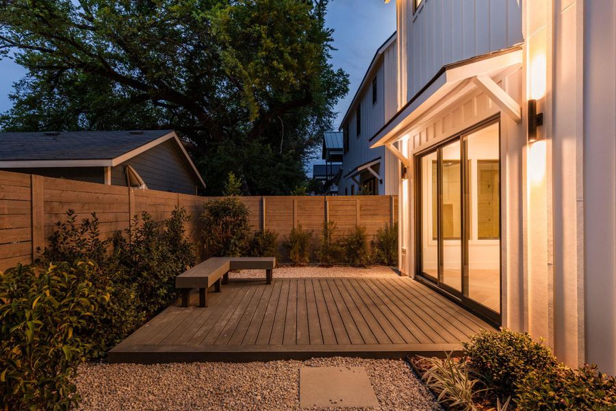Fenced backyard with a wooden deck Fenced backyard with a wooden deck