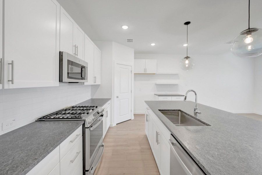 Lovely kitchen with granite counters and white cabinets Lovely kitchen with granite counters and white cabinets