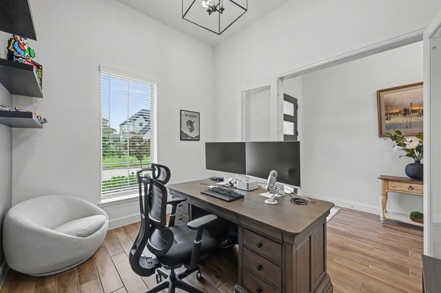 The private study is separate from the gathering area of the home and the shelving will stay. Another large chandelier adds a custom feel to this space. A floor plug was added for convenience. The private study is separate from the gathering area of the home and the shelving will stay. Another large chandelier adds a custom feel to this space. A floor plug was added for convenience.