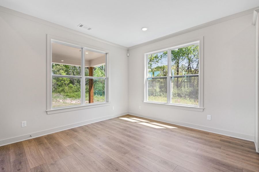 Unfurnished room with light wood-style floors, ornamental molding, and recessed lighting