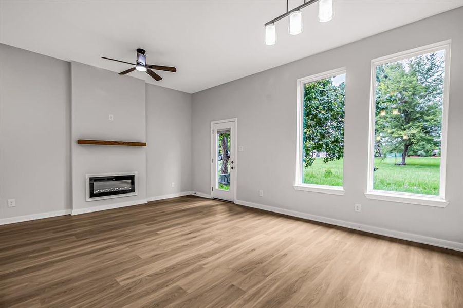 The living room has an electric fireplace focal wall with large windows overlooking the green belt behind the home. Enjoy the green space without having to maintain it!