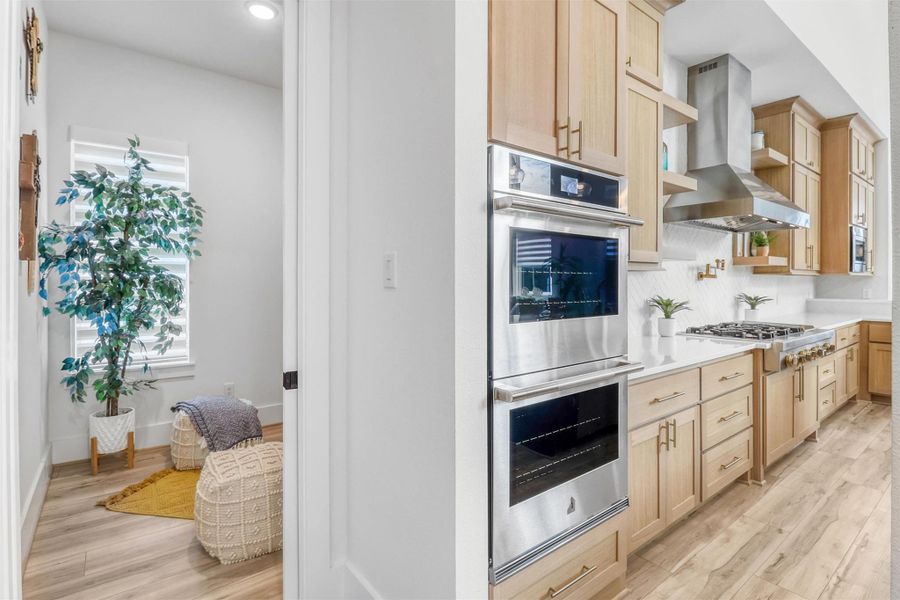 Off to the side of the kitchen, there is an extra room custom-built by the owners to be a place of quiet solitude and peace. The space is approximately 7'x8' and could potentially be used as an additional office space, pantry, library, or storage.