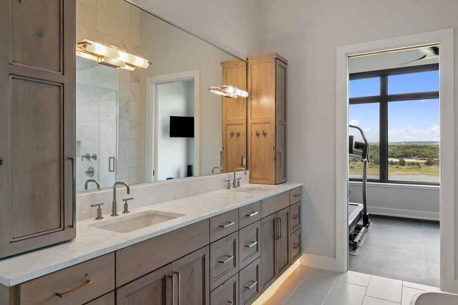 Double vanity featuring undermount sinks, stone countertops, and brushed nickel fixtures