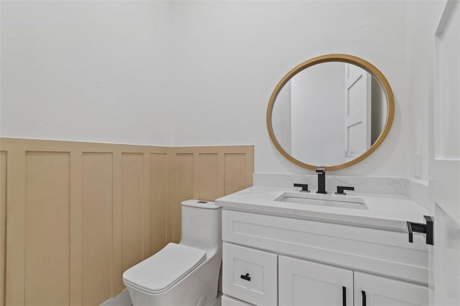 Bathroom featuring vanity and toilet