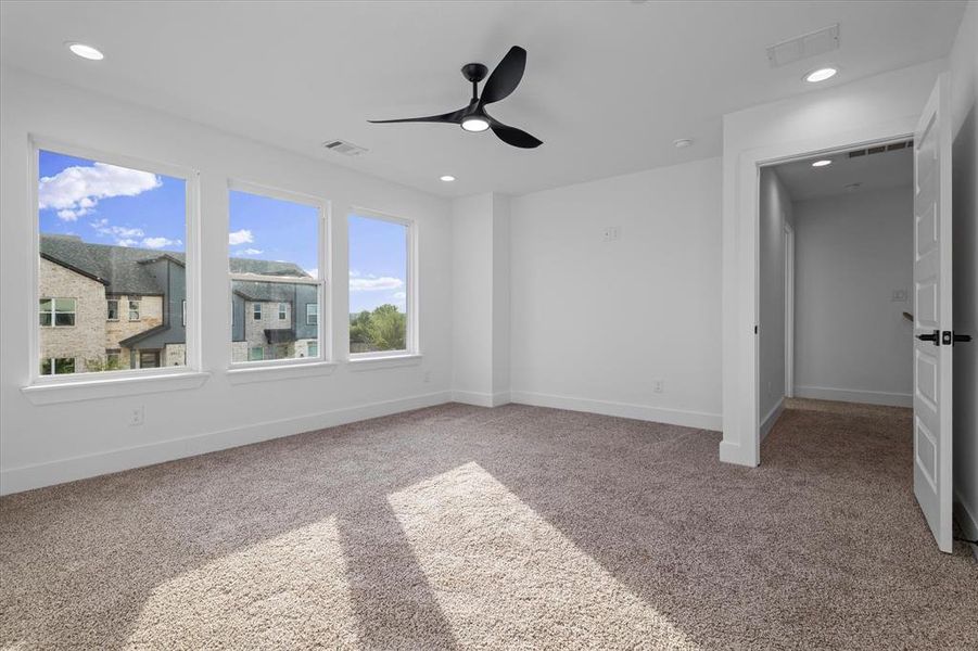 Unfurnished bedroom featuring light colored carpet, recessed lighting, and a ceiling fan Unfurnished bedroom featuring light colored carpet, recessed lighting, and a ceiling fan