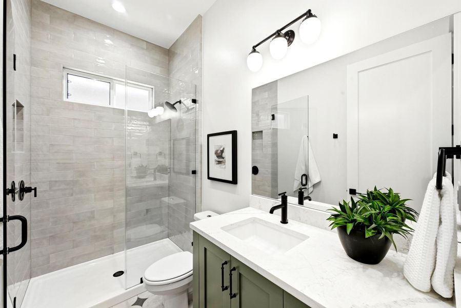 A well-appointed bathroom features a spacious walk-in shower with sleek glass enclosure and a stylish vanity with ample counter space. A well-appointed bathroom features a spacious walk-in shower with sleek glass enclosure and a stylish vanity with ample counter space.