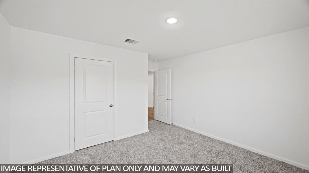 Unfurnished bedroom featuring light carpet and baseboards