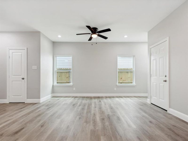 Unfurnished room with ceiling fan and light hardwood / wood-style floors