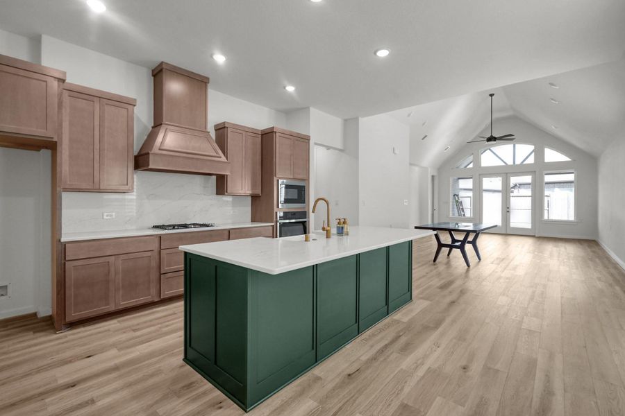 As you enter the gathering space of the home you are greeted by the open kitchen, dining and family rooms. There is recessed lighting throughout this part of the home.