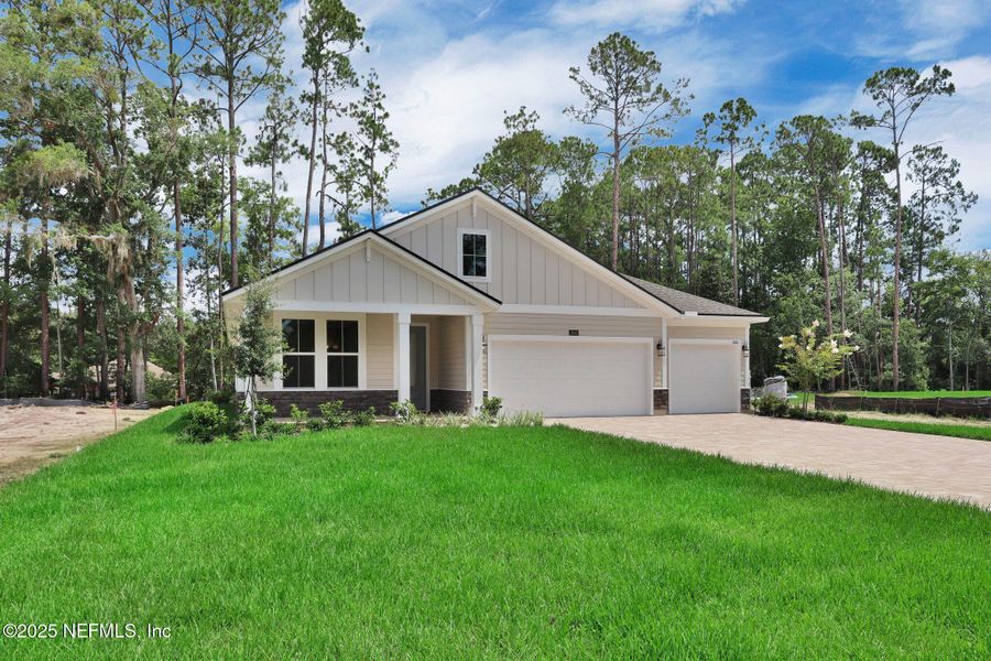 Front exterior of a new home in Creighton Pointe, Fleming Island, FL, highlighting curb appeal (Image 25). Front exterior of a new home in Creighton Pointe, Fleming Island, FL, highlighting curb appeal (Image 25).