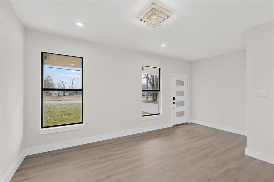Spare room featuring light wood-style floors and recessed lighting Spare room featuring light wood-style floors and recessed lighting